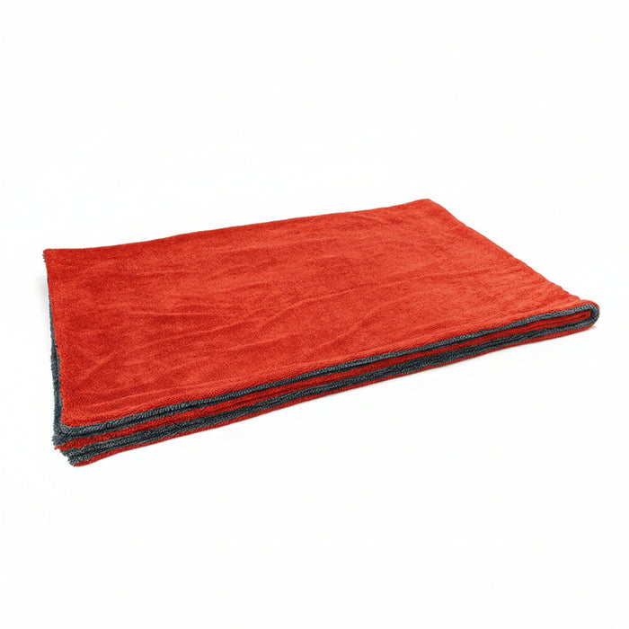 Folded red towel with gray edge on a white background